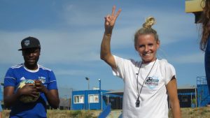 Julia Simic smiling and waving at the YB Arena.