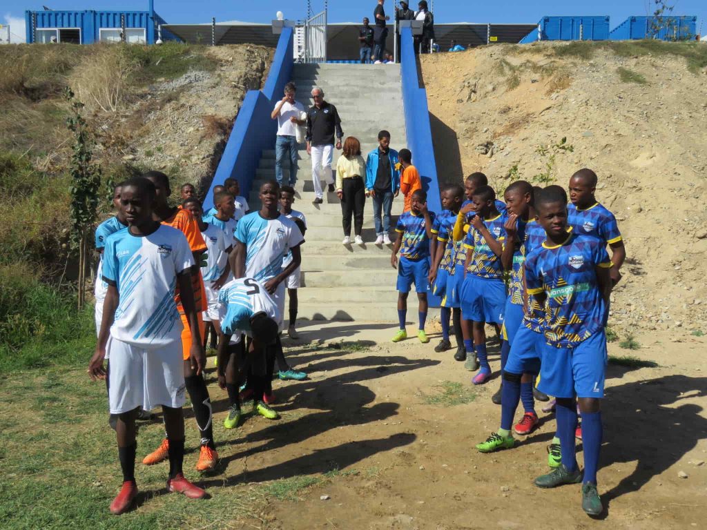 Two teams of the NGO Young Bafana Soccer Academy lining up for a show match during the YB Arena opening.